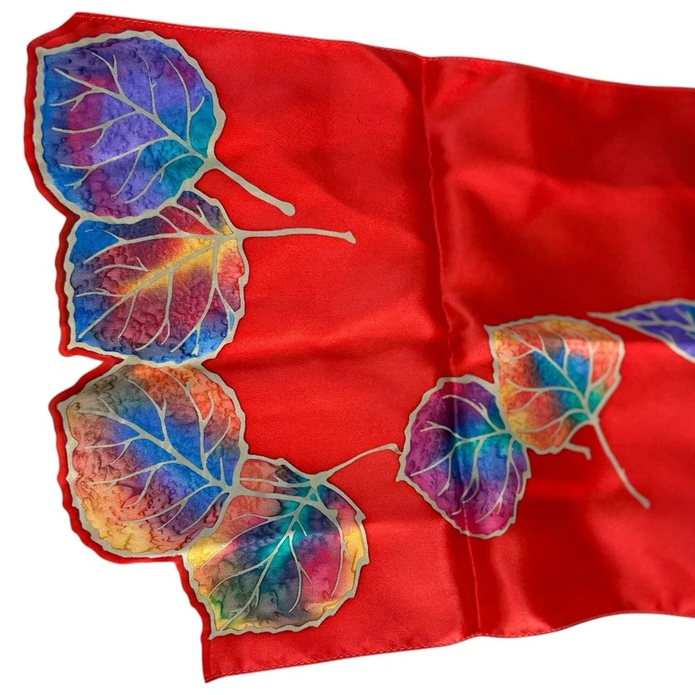 Kriska hand painted silk scarf. Red with multicolored leaves and cutouts. NWOT